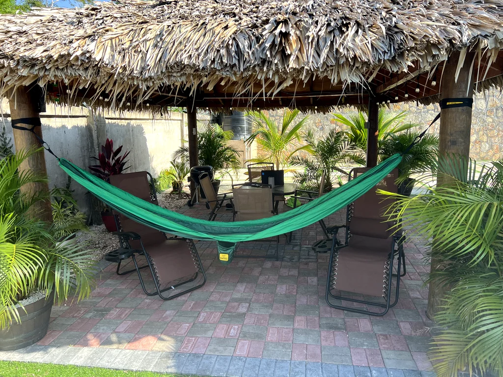Relaxing green hammock under the shade of the backyard gazebo