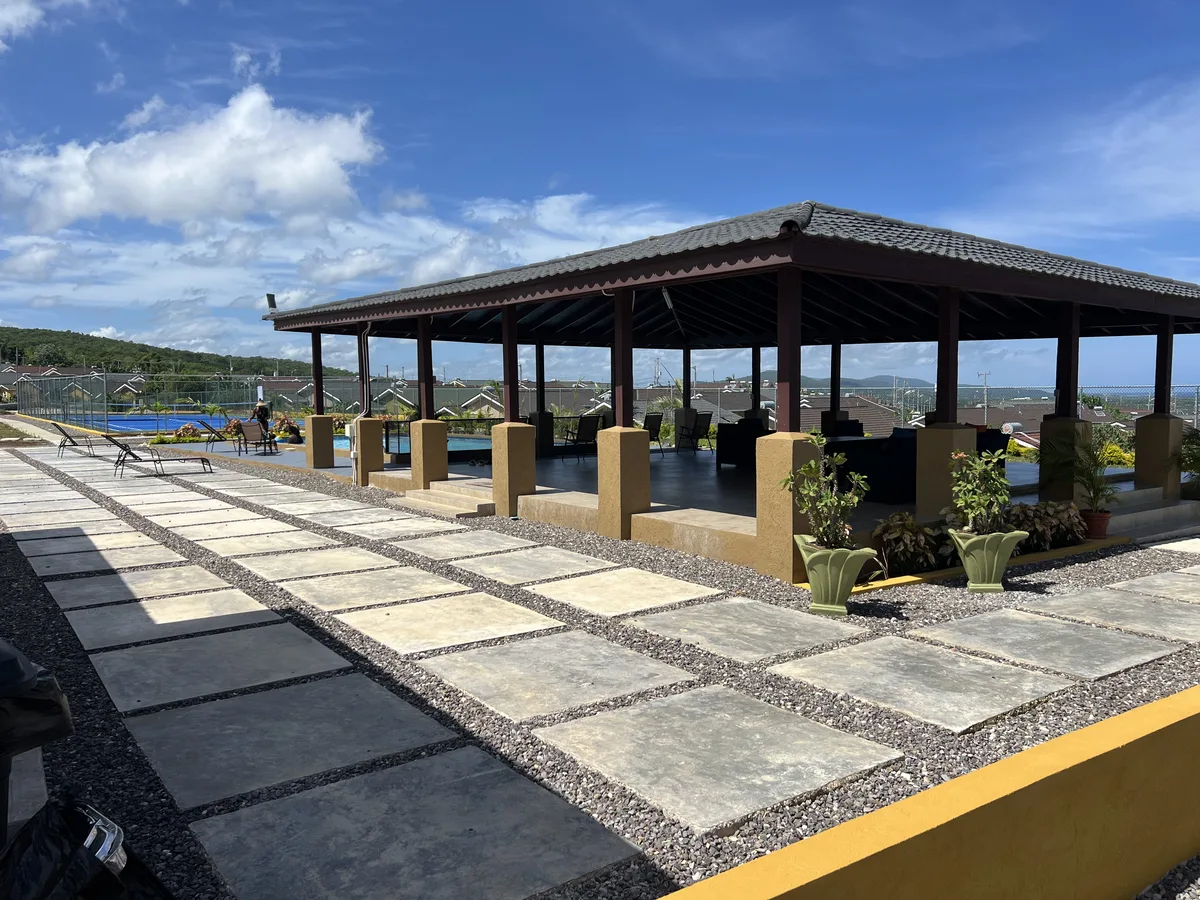 Covered clubhouse pavilion with stone pathways at Stonebrook Manor Estates