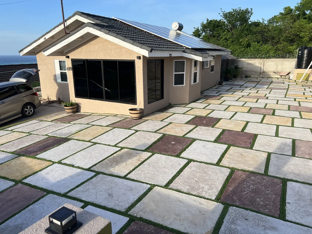 Villa entrance with warm accent lights and paved driveway at Miramar Villa 499